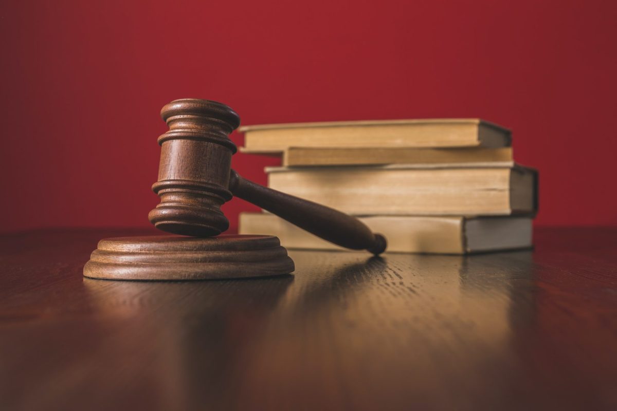 juridical-books-with-hammer-on-wooden-table-law-concept-e1648385409924.jpg